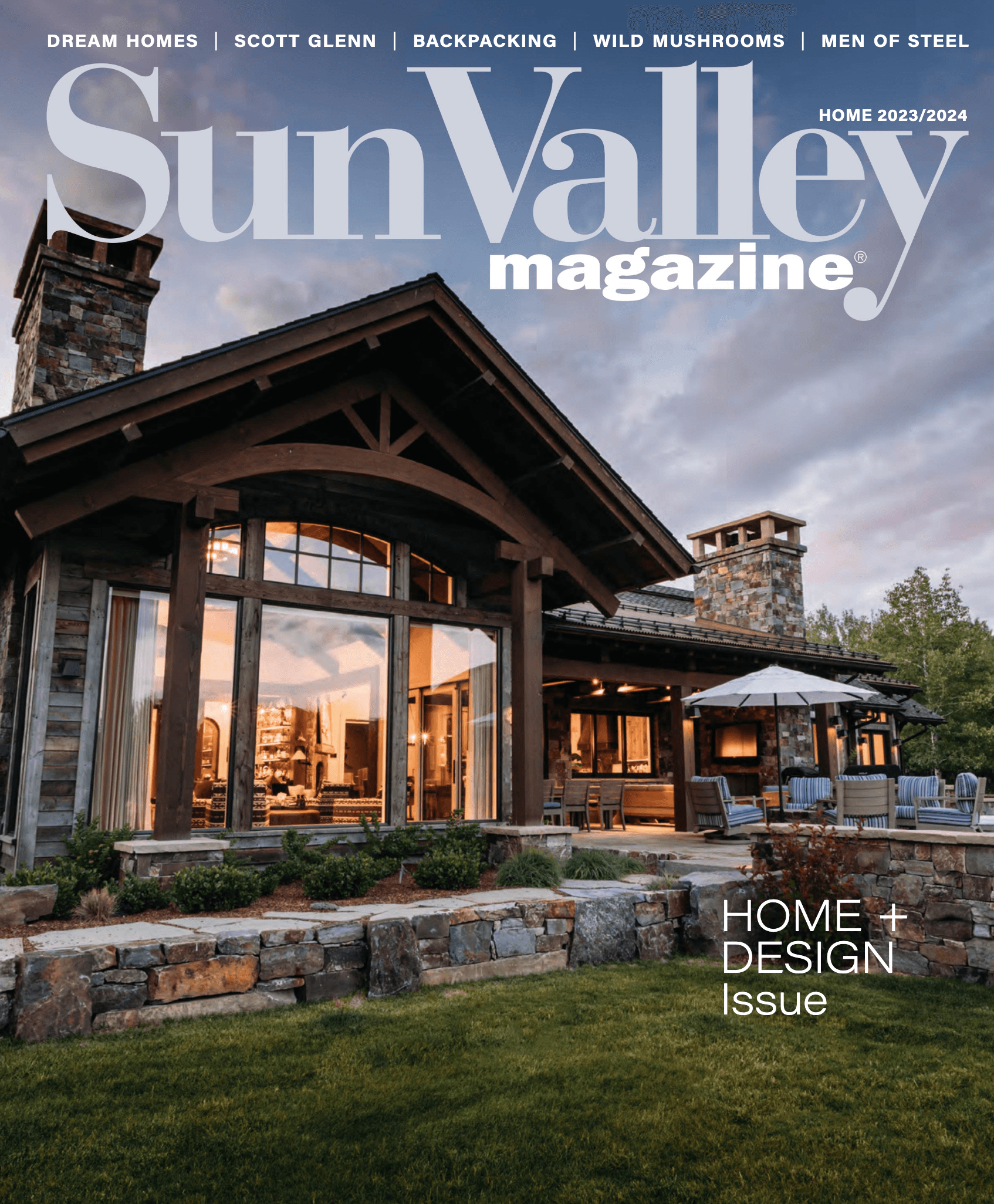 Cover of the Sun Valley Magazine Home + Design issue, showing a stone and timber home at dusk