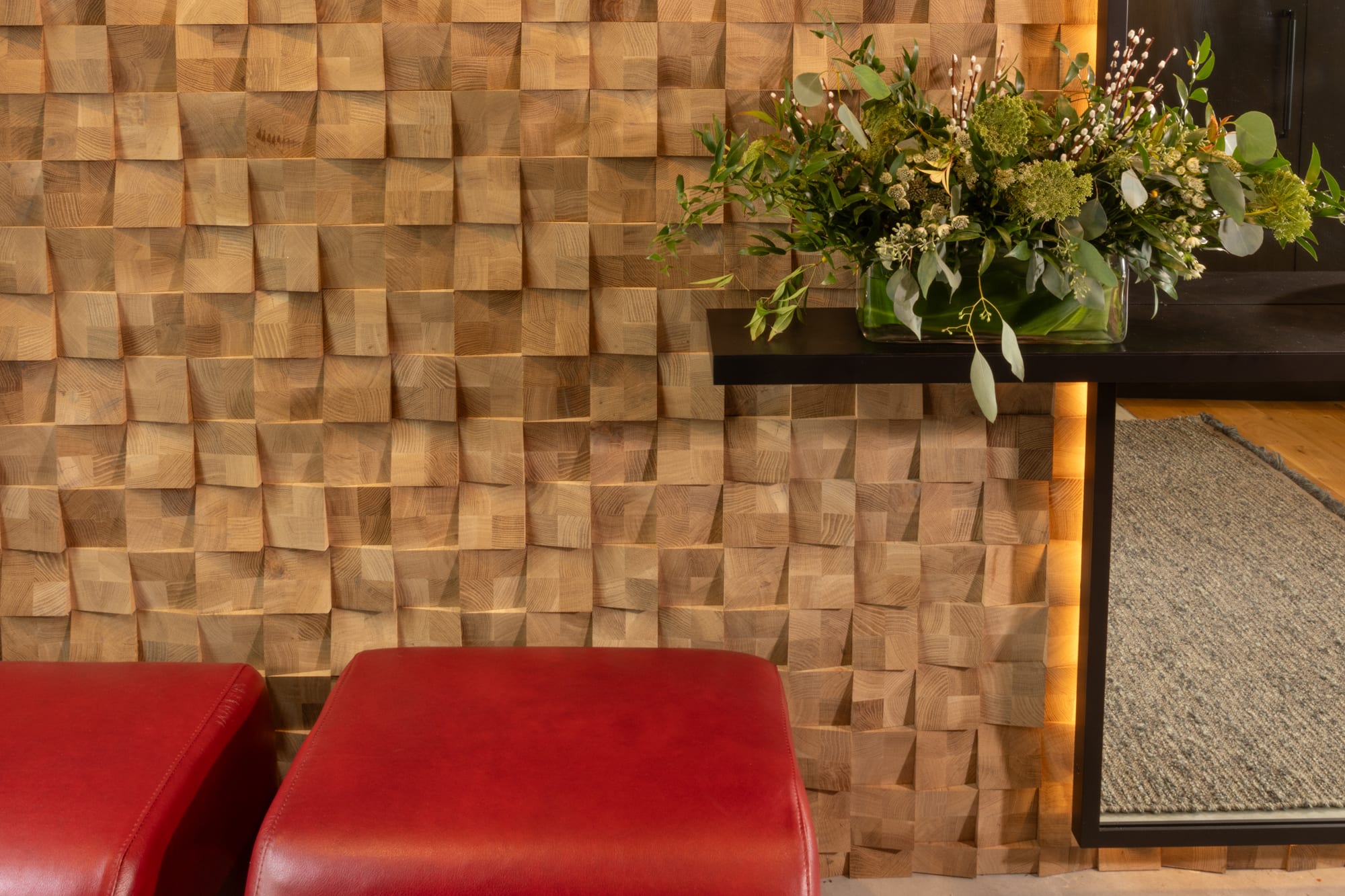 Textured wall with flowers and red ottomans