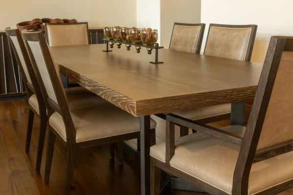 Textured oak dining table with leather-upholstered chairs